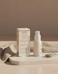 The Eye Smoothing Serum — Step 2 Smooth, box and pump on oatmeal linen