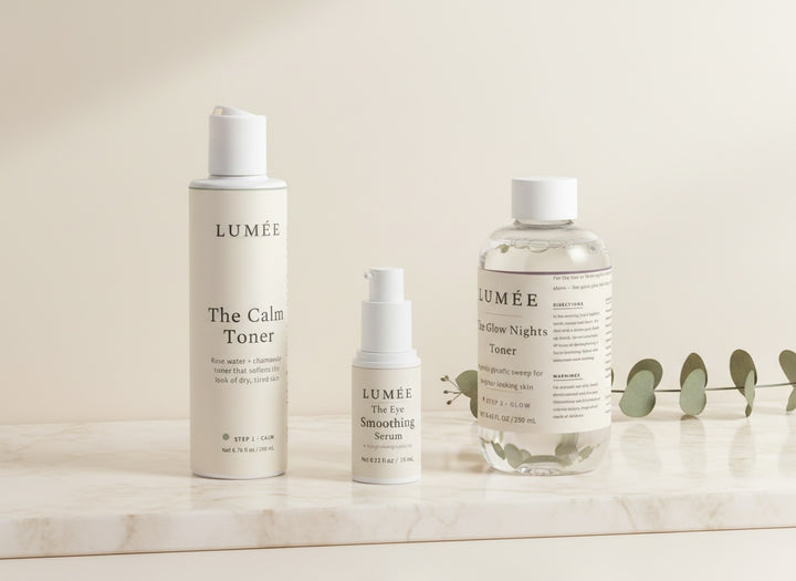 The Fresh Face Ritual — the three bottles together: Step 1 The Calm Toner, Step 2 The Eye Smoothing Serum, Step 3 The Glow Nights Toner, on warm marble in morning light